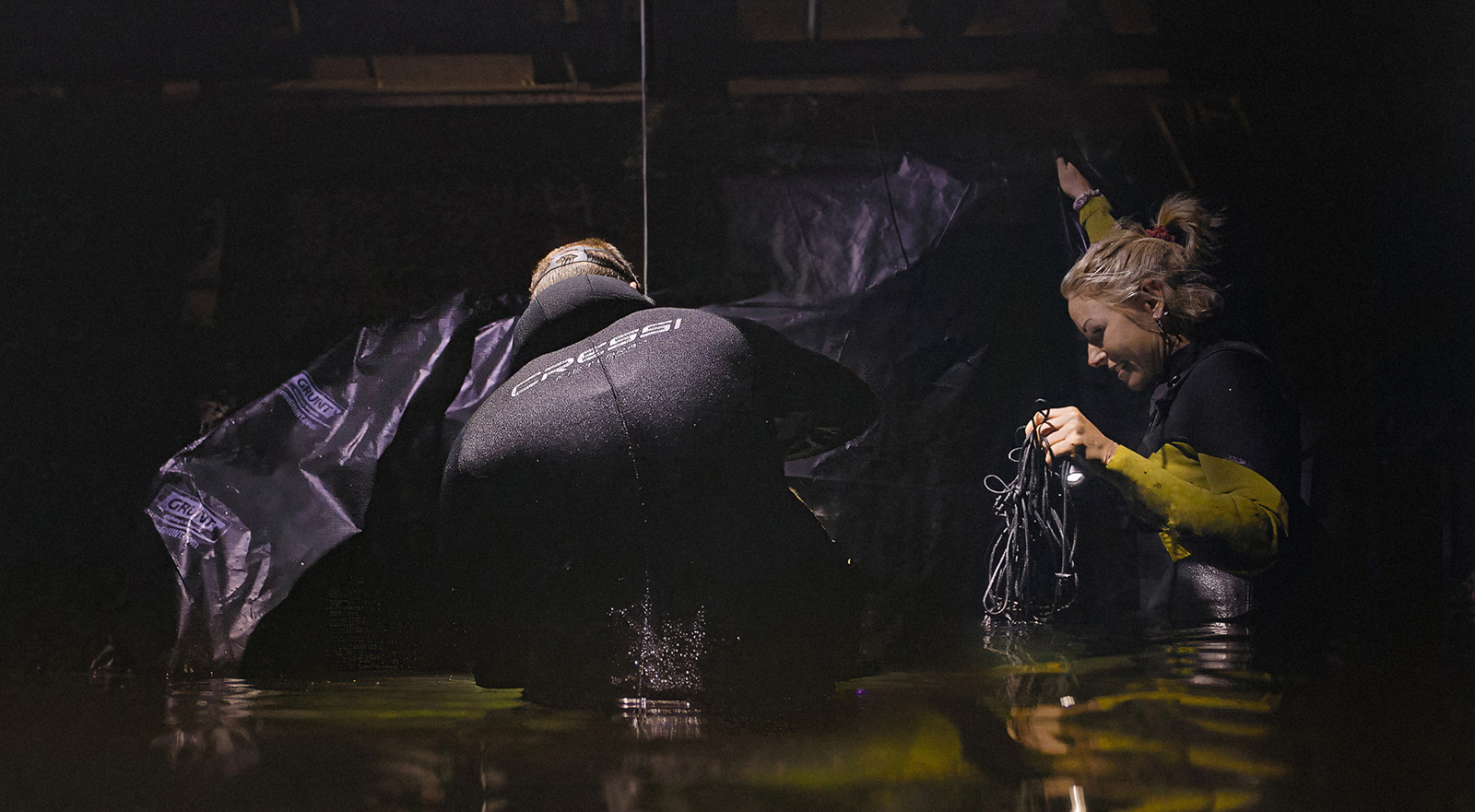 Matt Bagley in the water building his set, wrapping a black backdrop